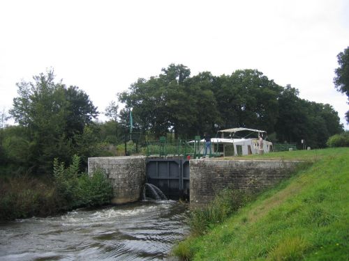 so she starts to let some water out the bottom of the lock
